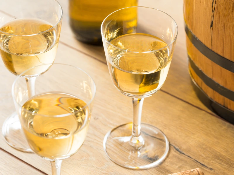 Dessert wine sherry in glasses on wododen table